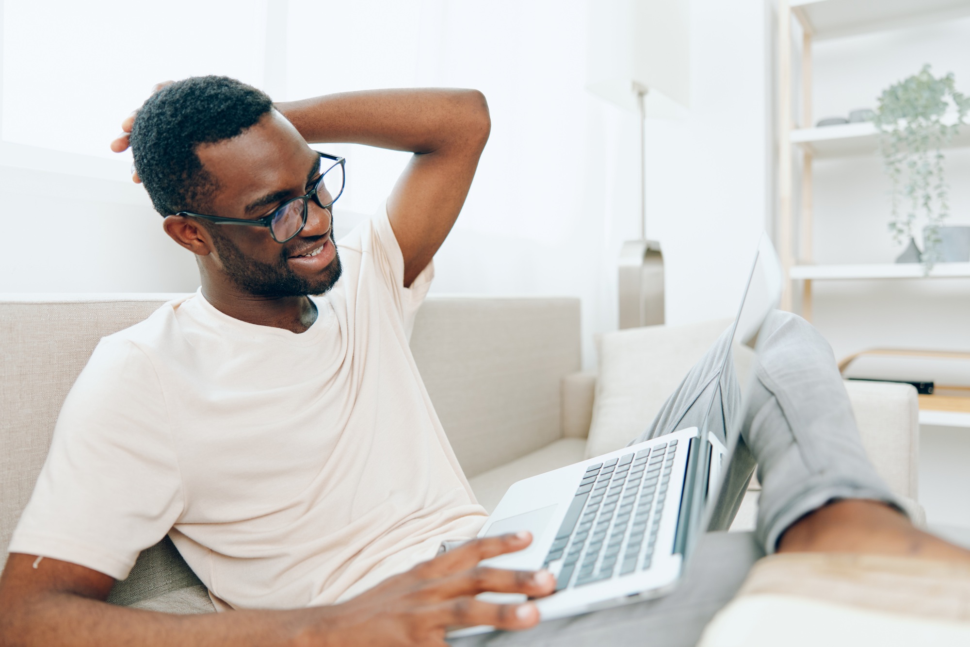 Smiling African American Freelancer Working on Laptop in Modern Home Office